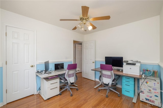 office space with a ceiling fan and light wood-style floors