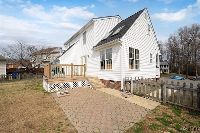 rear view of house featuring a deck, a fenced backyard, a yard, crawl space, and a patio area