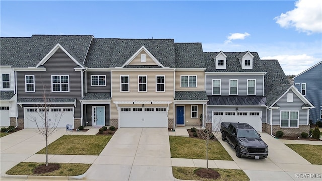 multi unit property with concrete driveway, a front lawn, brick siding, and an attached garage