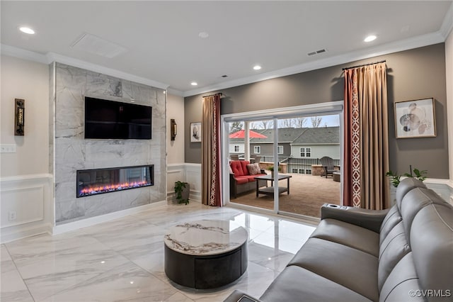 living area featuring crown molding, a fireplace, marble tiled flooring, a decorative wall, and recessed lighting