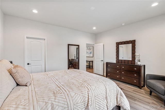 bedroom with recessed lighting and light wood-style floors