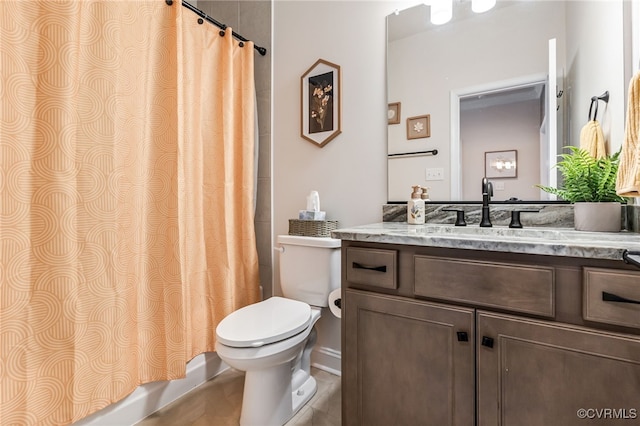 bathroom featuring shower / bath combination with curtain, toilet, and vanity