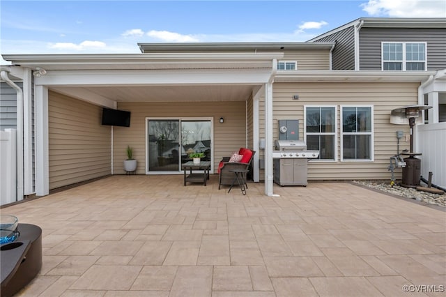 view of patio / terrace with a grill and fence