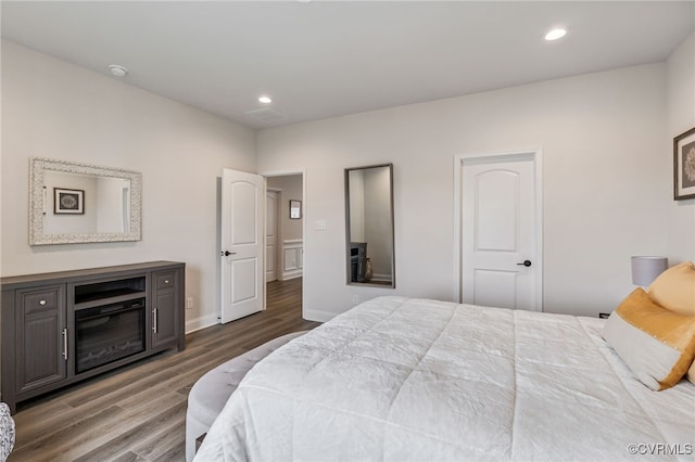 bedroom with wood finished floors and recessed lighting