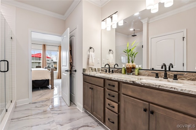 ensuite bathroom featuring double vanity, a sink, a shower stall, crown molding, and marble finish floor