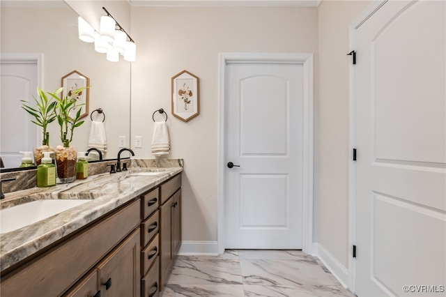bathroom with marble finish floors, double vanity, and baseboards