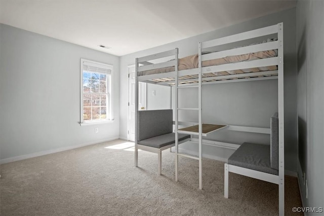 unfurnished bedroom with visible vents, carpet floors, and baseboards