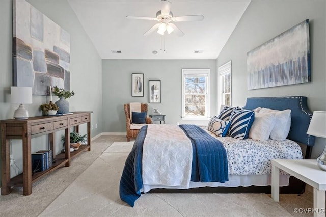 carpeted bedroom with visible vents, baseboards, and ceiling fan