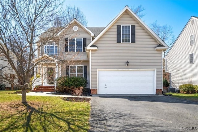 traditional-style house with central AC unit, driveway, and an attached garage