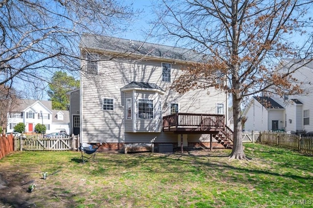 rear view of property featuring stairway, a gate, a yard, a fenced backyard, and a deck