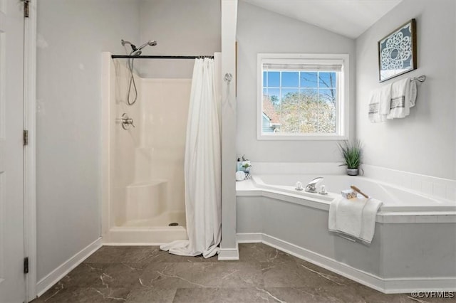 bathroom with a bath, a stall shower, baseboards, and lofted ceiling