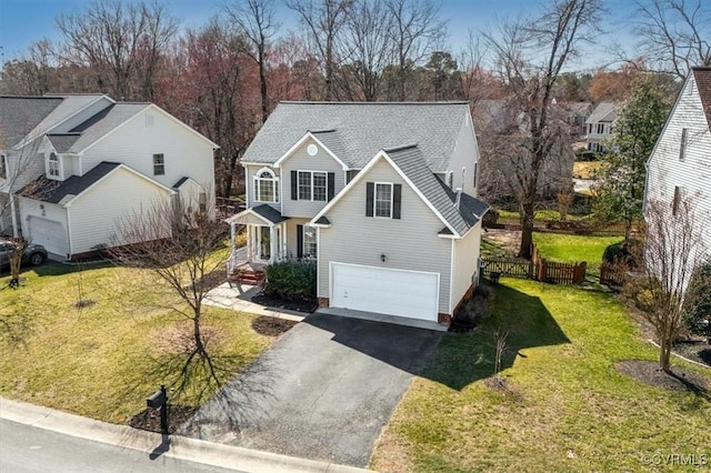 view of front of home featuring fence, driveway, an attached garage, a shingled roof, and a front lawn