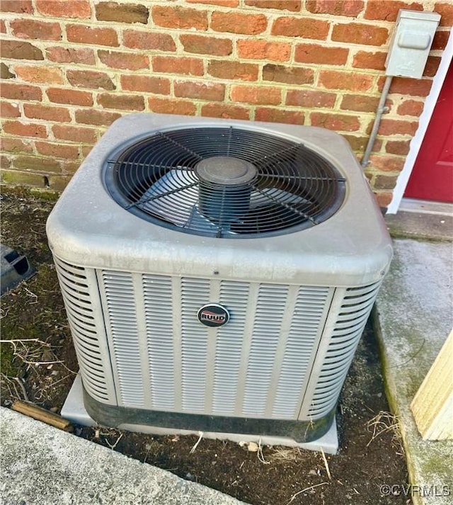 details featuring brick siding and central AC unit