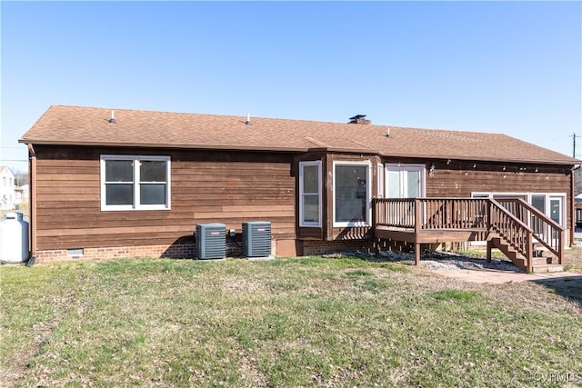 rear view of house with crawl space, a deck, a lawn, and cooling unit