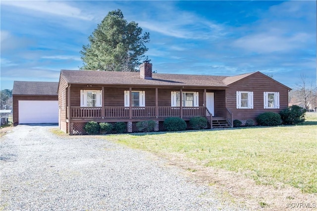 ranch-style home with an outbuilding, covered porch, a chimney, a front lawn, and a garage