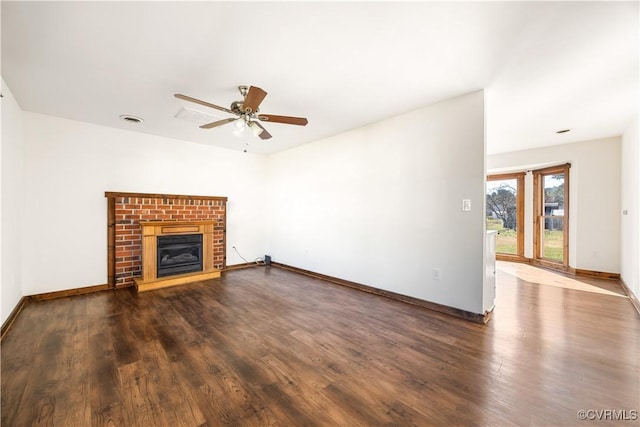 unfurnished living room with visible vents, baseboards, a fireplace, a ceiling fan, and dark wood-style flooring