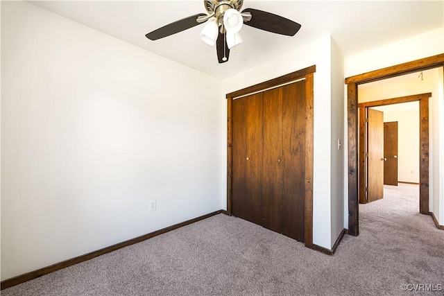 unfurnished bedroom with a closet, baseboards, and carpet