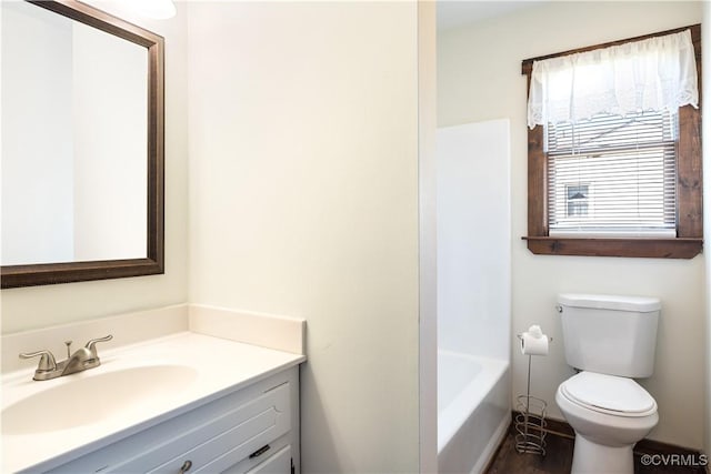 bathroom with a washtub, toilet, vanity, and walk in shower