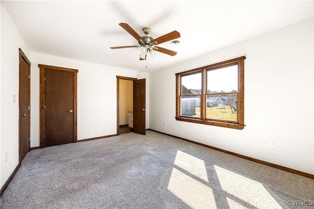 unfurnished bedroom with a ceiling fan, visible vents, baseboards, and light carpet