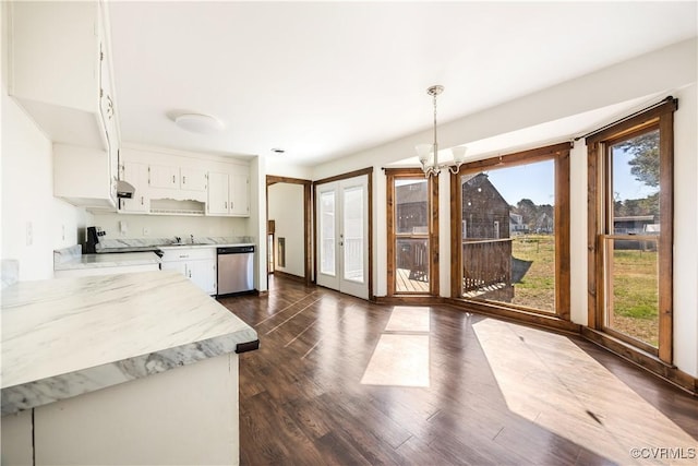 kitchen featuring dark wood finished floors, stove, white cabinets, stainless steel dishwasher, and decorative light fixtures