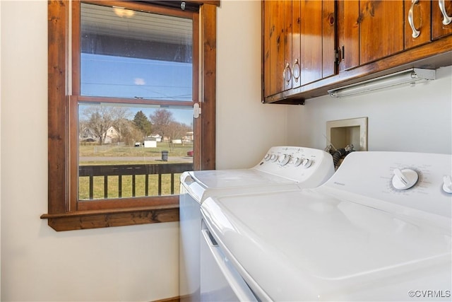 laundry room with washing machine and dryer and cabinet space