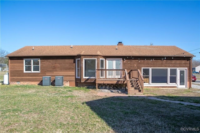 rear view of house with a deck, a yard, roof with shingles, crawl space, and a chimney