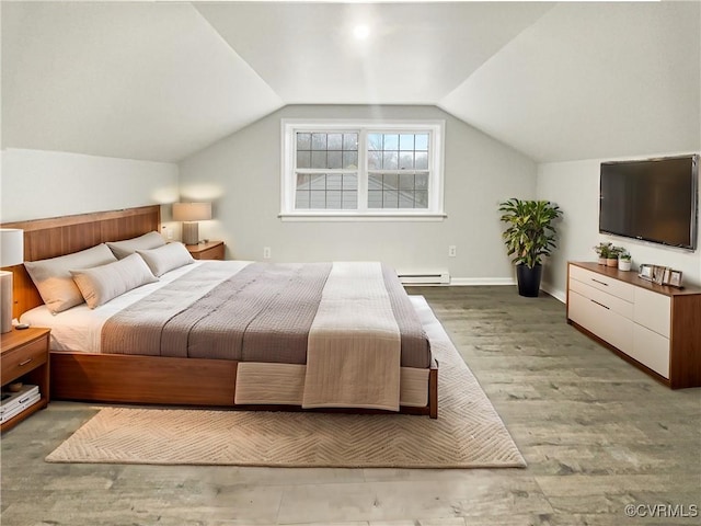 bedroom featuring baseboards, lofted ceiling, and wood finished floors