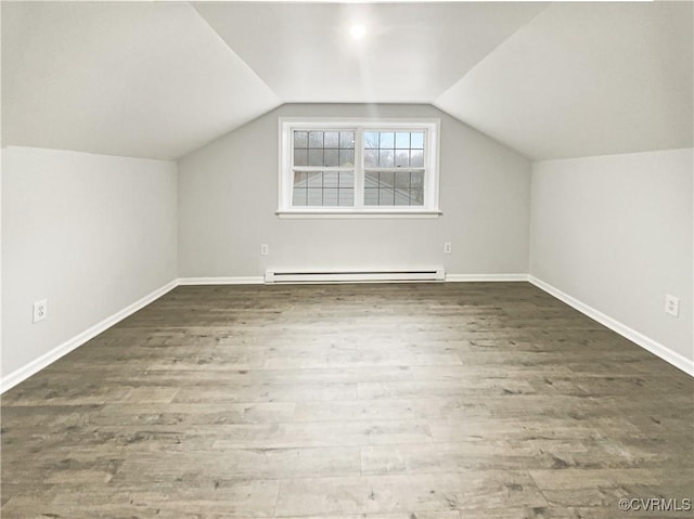 bonus room with baseboard heating, baseboards, lofted ceiling, and wood finished floors