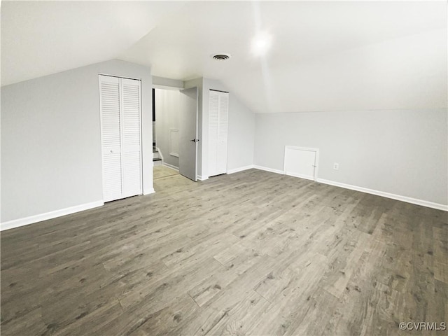 additional living space featuring visible vents, baseboards, and wood finished floors