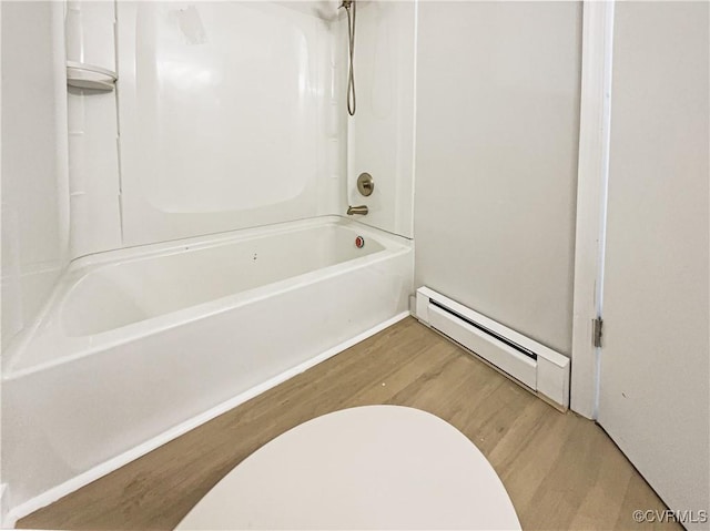 full bath featuring wood finished floors, shower / tub combination, and a baseboard radiator