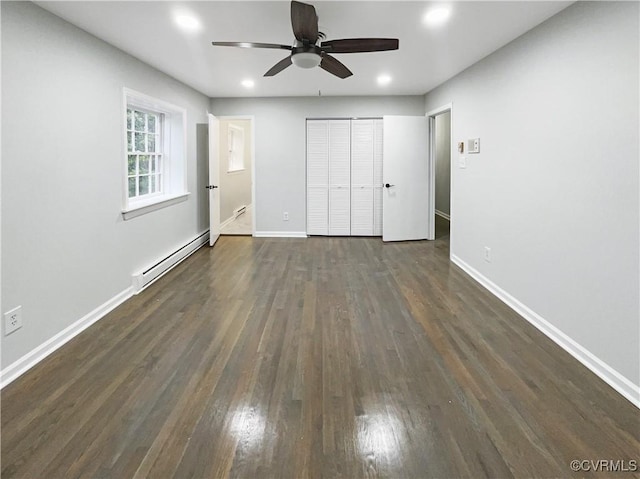 unfurnished bedroom with recessed lighting, a baseboard radiator, baseboards, and dark wood-type flooring