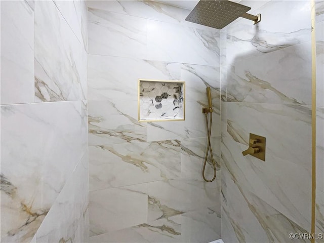 bathroom featuring a marble finish shower