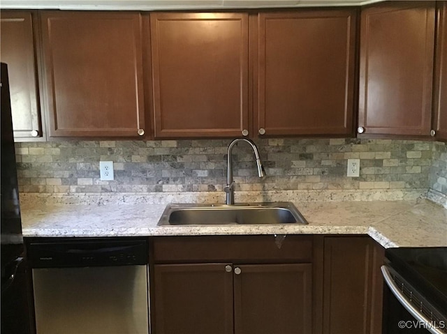 kitchen featuring a sink, backsplash, stainless steel dishwasher, and light countertops