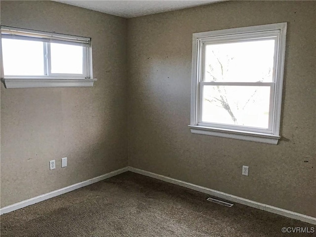 unfurnished room featuring visible vents, baseboards, and carpet floors