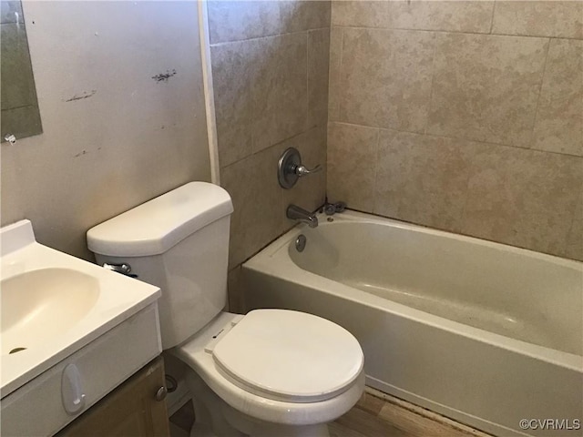 bathroom with shower / bath combination, toilet, vanity, and wood finished floors