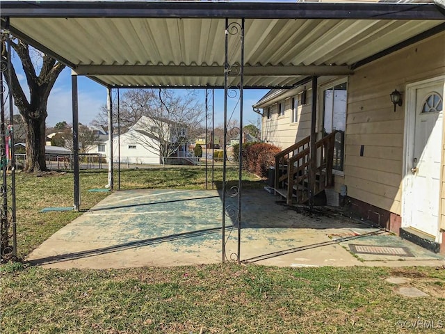 view of patio with fence, a carport, and entry steps