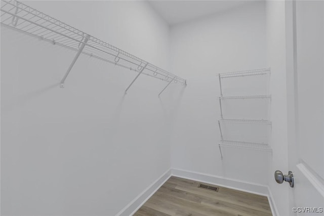 spacious closet with visible vents and wood finished floors