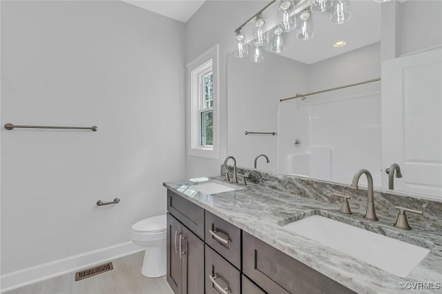 full bath featuring a sink, visible vents, baseboards, and toilet