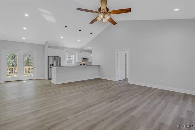 unfurnished living room featuring light wood finished floors and baseboards