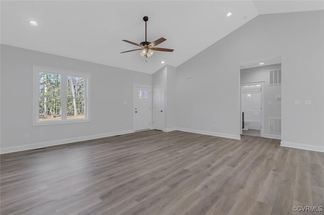 unfurnished living room featuring ceiling fan, visible vents, baseboards, and wood finished floors