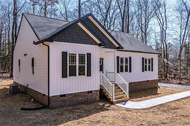 view of front of house featuring crawl space, central AC unit, and roof with shingles