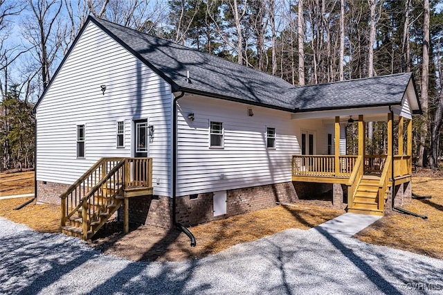 view of side of property featuring crawl space and a shingled roof