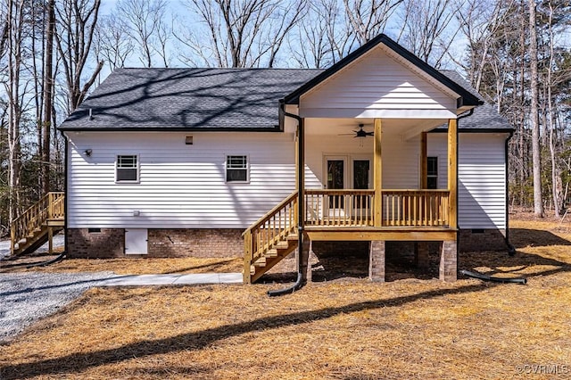 rear view of property featuring crawl space, roof with shingles, ceiling fan, and stairway