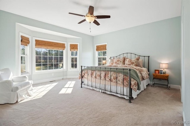 bedroom with baseboards, carpet floors, and ceiling fan