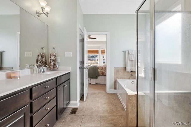 ensuite bathroom featuring vanity, a garden tub, ensuite bath, a shower stall, and tile patterned floors