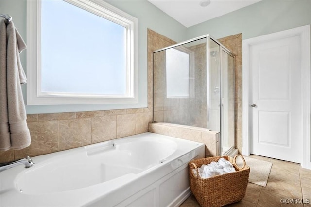 full bathroom with tile patterned flooring, a bath, and a stall shower