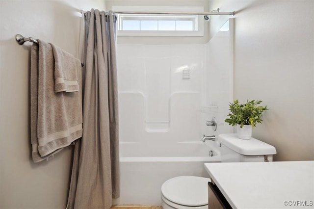 bathroom featuring shower / bathtub combination with curtain, toilet, and vanity