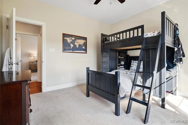 carpeted bedroom with baseboards and a ceiling fan