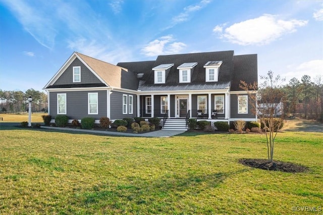 cape cod-style house featuring a porch and a front yard