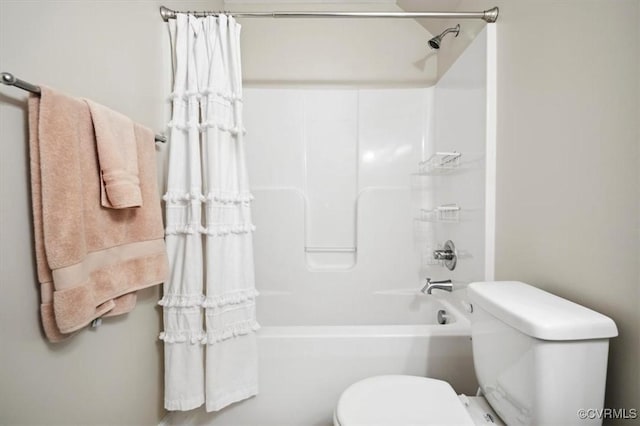 bathroom featuring shower / bathing tub combination and toilet